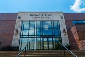 Front view of Thomas R. Kline School of Law building on a sunny day with a clear sky.